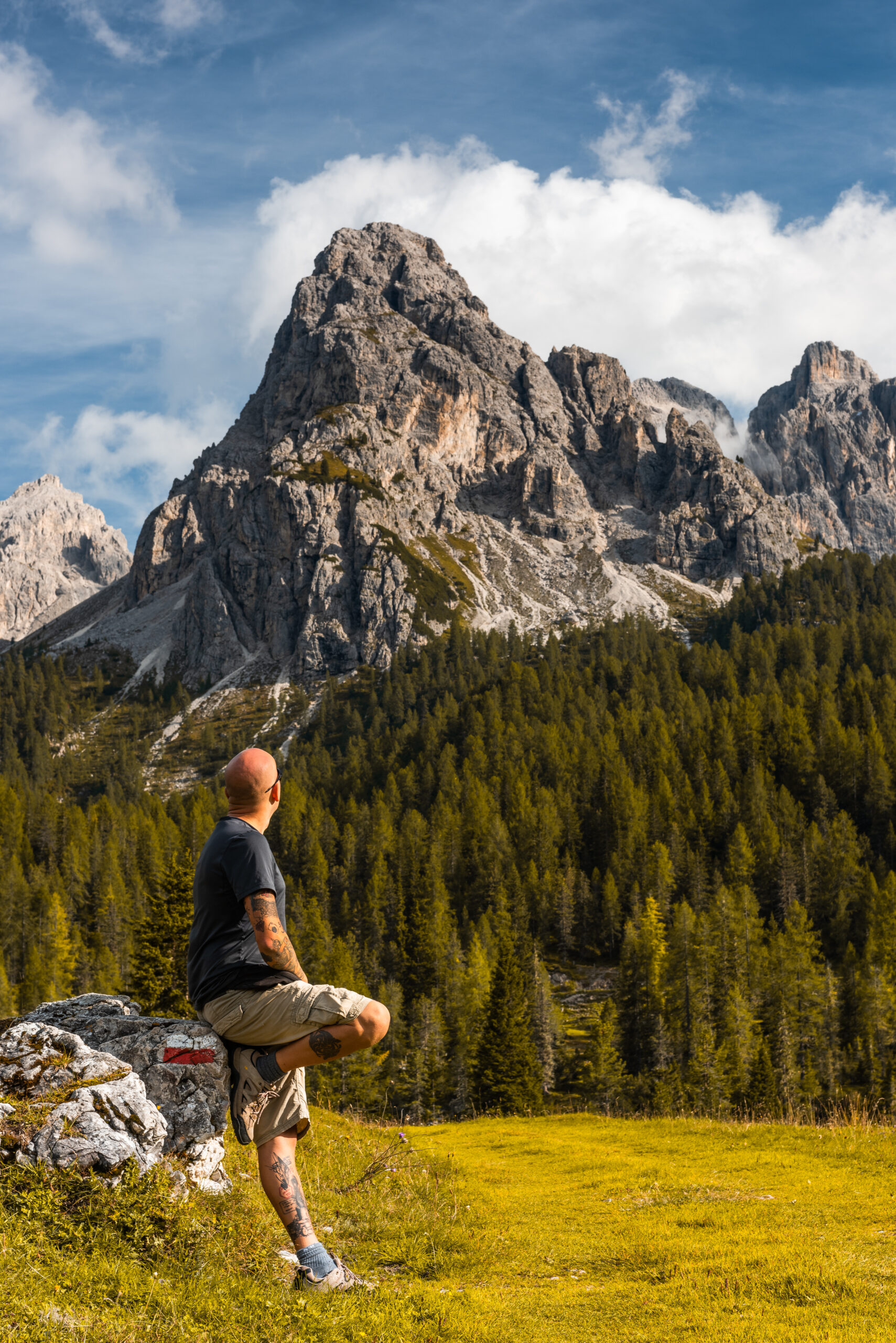 Adventure Man Sitting on Rock after Solo Hiking Mountains.